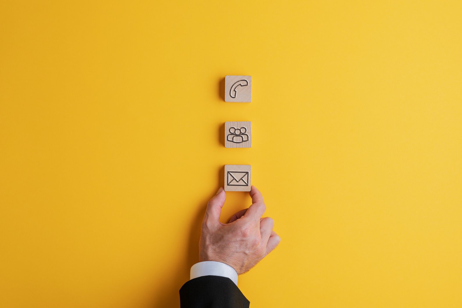 Placing Three Wooden Blocks with Contact and Communication Icons